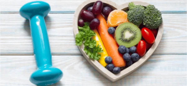 A bowl full of vegetables with dumbbell for weight loss