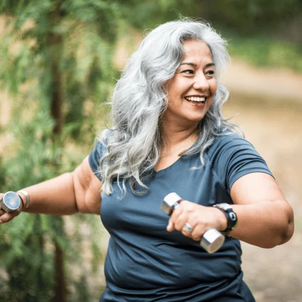 Happy elder woman holding dumbbells_Compressed